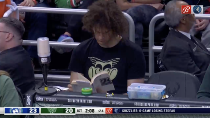 Robin Lopez reads a book at the Bucks-Timberwolves game